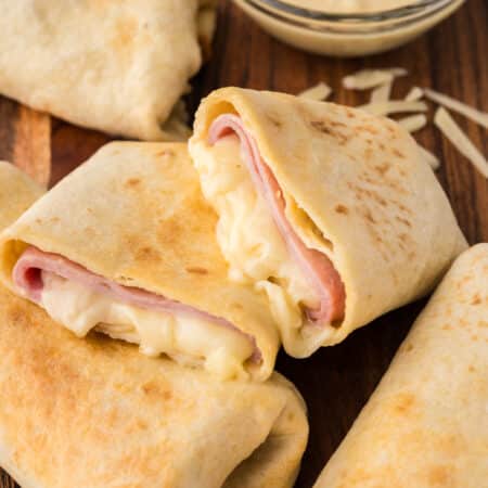 Close-up of a split air fryer ham and cheese wrap.
