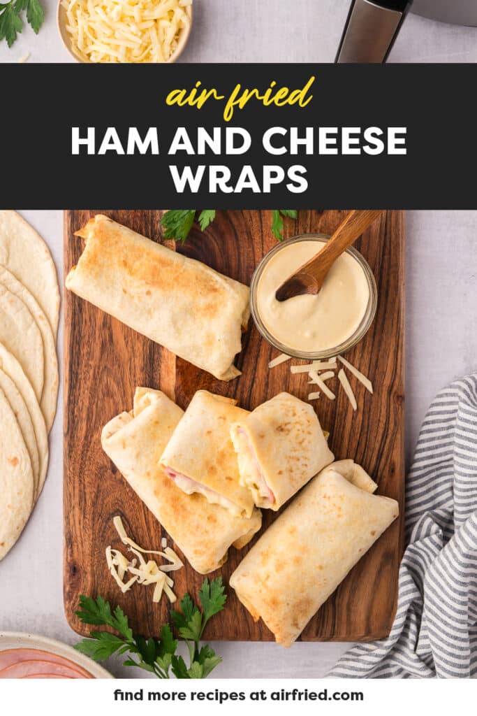 A few air fryer ham and cheese wraps on a wooden cutting board.